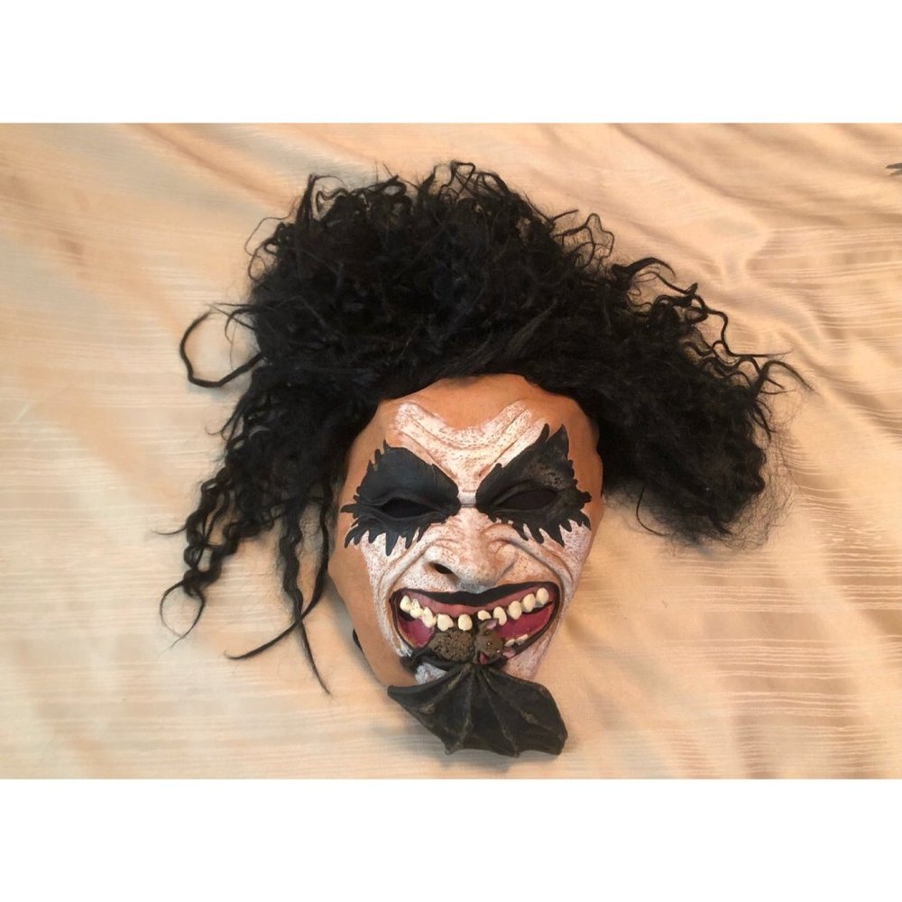 Creepy Halloween mask with bat in it’s teeth